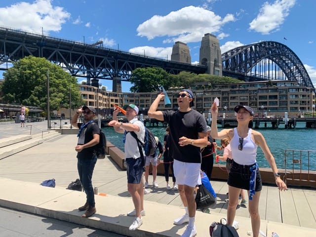 The Rocks Sydney Amazing Races hosted checkpoints takes flight by the Sydney Harbour Bridge facilitated team activities no acting just professional staff engagement.